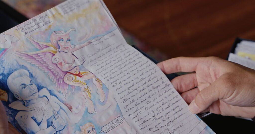 Still photo from “Love, Jamie” of Gabriel holding one of Jamie’s illustrated letters, courtesy of American Masters