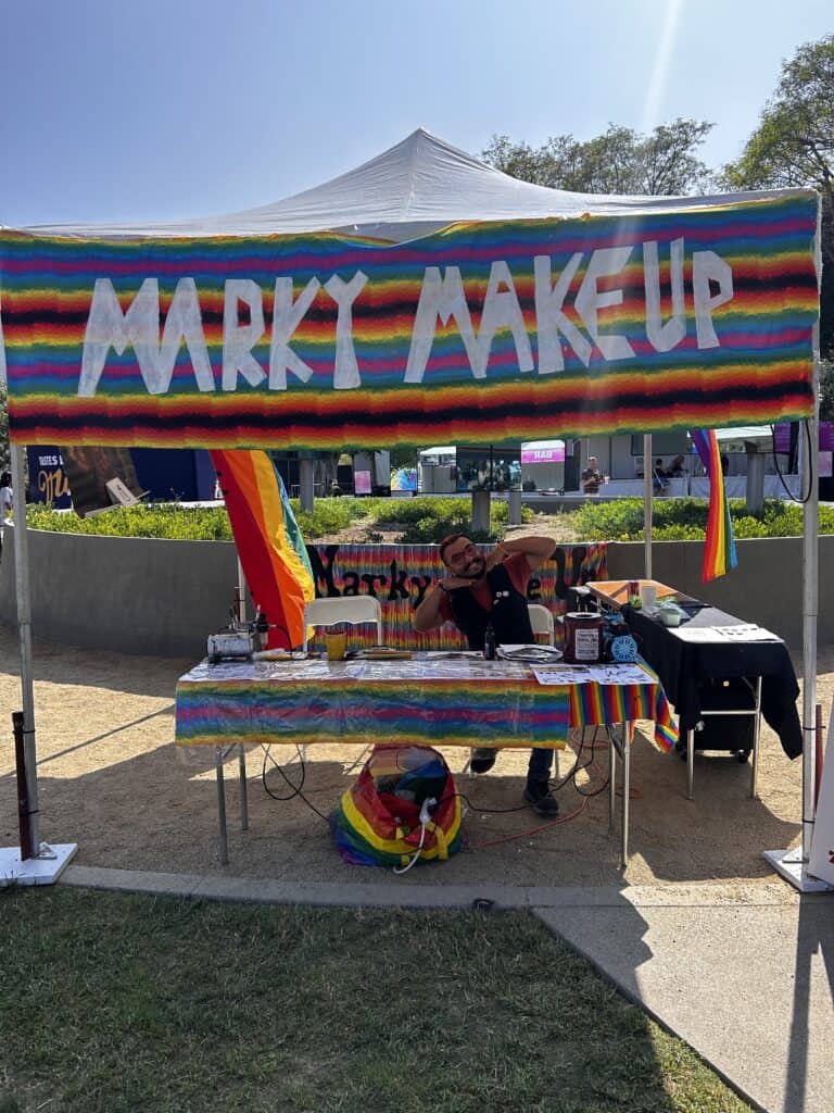 A photo of a makeup and face tattoo booth at the Pride Street Fair. Credit: Blossom Brown