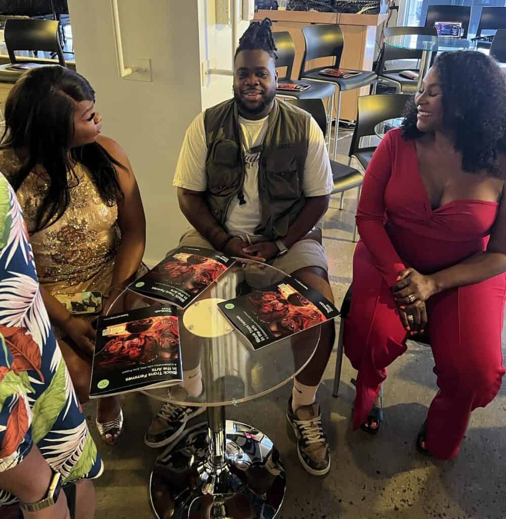 Kayla Gore, Oluchi Omeoga, and Breonna McCree sitting backstage with TransLash Zine Vol. 7: Black Trans Femmes in the Arts before the "American Problems, Trans Solutions" screening.